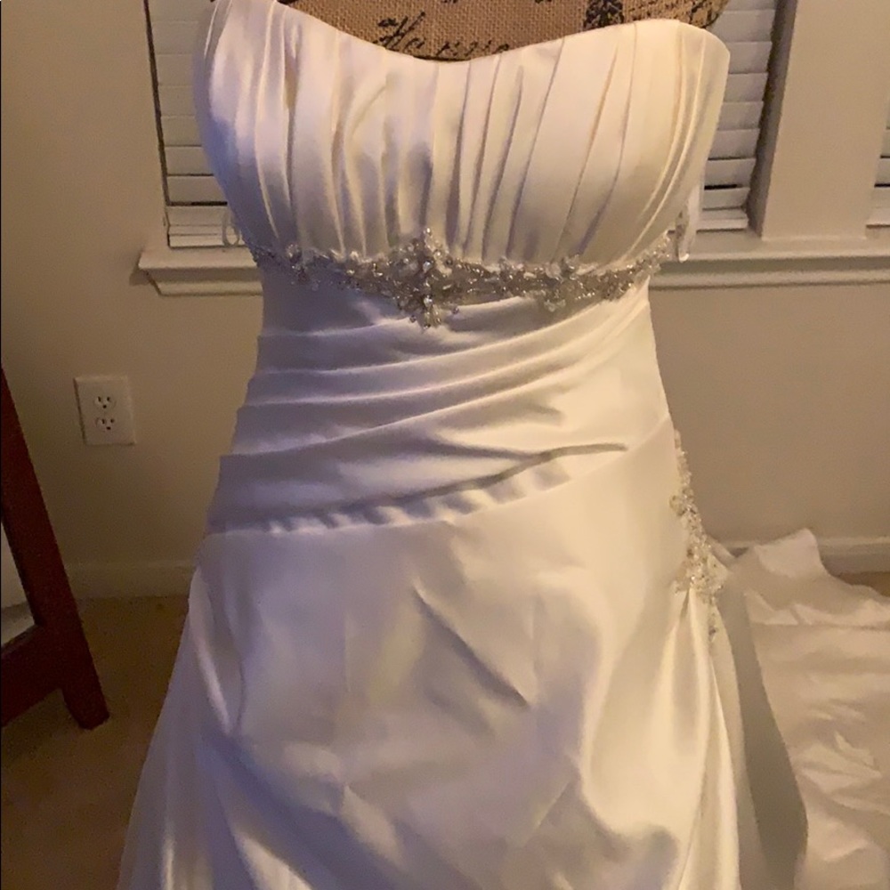 A brand new Ella Rosa wedding gown